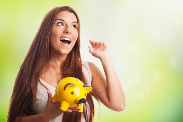 woman-dreaming-holding-piglet-moneybox